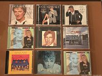 Front view of nine CD cases showing album artwork