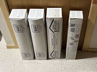 Four tall Sears Services branded boxes standing upright