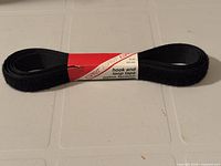 Front view of bundled black hook and loop tape with Esprit label facing up