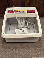 Top view showing foot bath interior, rollers, motor column, manual