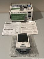 Boxed PowerCost Monitor kit with display, manuals