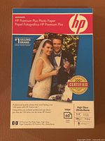 Front of sealed HP Premium Plus Photo Paper box showing brand, 4x6 in size, high gloss, 60 sheets