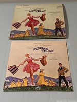 Front covers of the soundtrack LP and booklet shown side by side for verification of titles and artwork