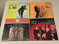 Front covers of the four LP albums arranged on table