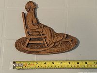 Full view of plaster relief with measuring tape for scale