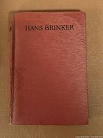 Front cover showing title and red cloth material