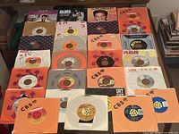 All 25 records laid out, sleeves and labels visible