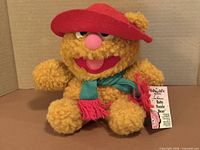 Front view of Baby Fozzie Bear plush with tag visible