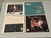 Front covers of all four record albums displayed on table