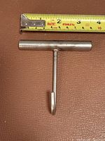 Front view showing full T-handle hook with measuring tape for scale