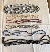 All six beaded necklace strands laid out to show colour assortment and length