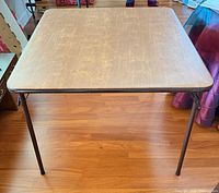 Top view of tan vinyl marbled card table