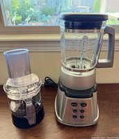Blender assembled on base; food processor attachment alongside