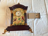 Front view of mantel clock and travel alarm clock together
