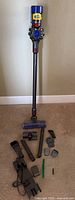 Full view of Dyson cordless stick vacuum with extension wand and floor head attached