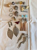 Full layout of rings, earrings, brooches on cloth background