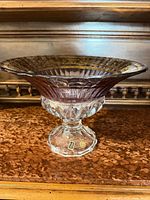 Side view of crystal pedestal bowl showing stem, flared rim and gold gilded band