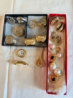 Overview of all earrings, clock, and brooch