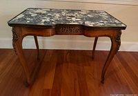 Full view of side table showing marble top, wood frame and bronze mounts
