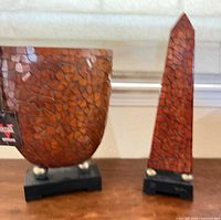 Vase and obelisk together on bases