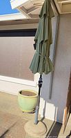 umbrella folded, pot and base visible