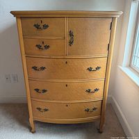 Front view showing 5 drawers, side cabinet, metal hardware