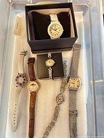 Overview of all six wristwatches in plastic tray