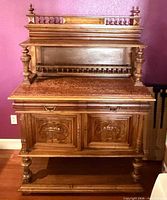 Full frontal view of server showing carved doors, drawers, stone top and upper gallery