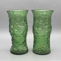 Two identical green crinkle glass vases front view