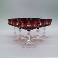 All six ruby red cut-to-clear coupes front view