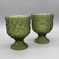 Two green crinkle glass pedestal compotes side by side