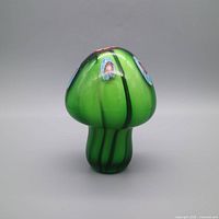 Front view of green glass mushroom with millefiori accents