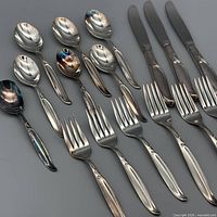 Mixed flatware showing knives, forks and spoons