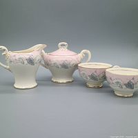 Full set showing creamer, sugar bowl with lid, and two teacups