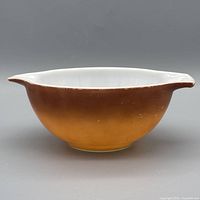 Side profile showing brown-orange ombre and one spout-handle