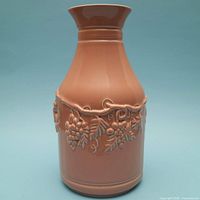 Full front view of vase showing color, shape, and grapevine relief