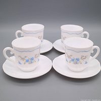 Full set of four cups each on its saucer