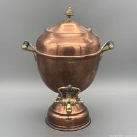 Front view of copper samovar-style urn with lid