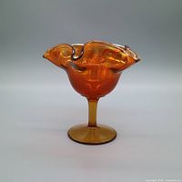 Side view of carnival glass compote showing pedestal and iridescent marigold color