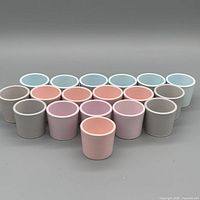 Front view of all 18 pastel shooter cups grouped by color
