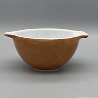 Side view of brown Pyrex Cinderella bowl showing exterior color and white interior