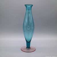 Full front view of aqua-teal vase with pink foot