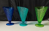 Three colored waffle-cone bowls side by side