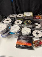 Stacks of white-label and commercial gospel CDs on table