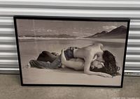 Full view of framed sepia photographic print leaning against wall