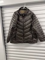 Front view of hooded quilted puffer coat on hanger