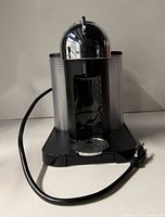 Front view showing entire machine, cord, reservoirs, drip tray