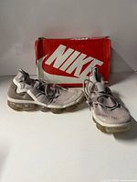 Top and side view of both sneakers with box