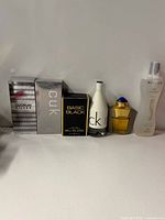 Group shot of four perfume items with boxes and bottles displayed