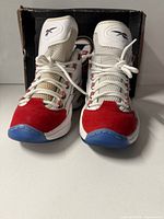 Front view of both sneakers with box